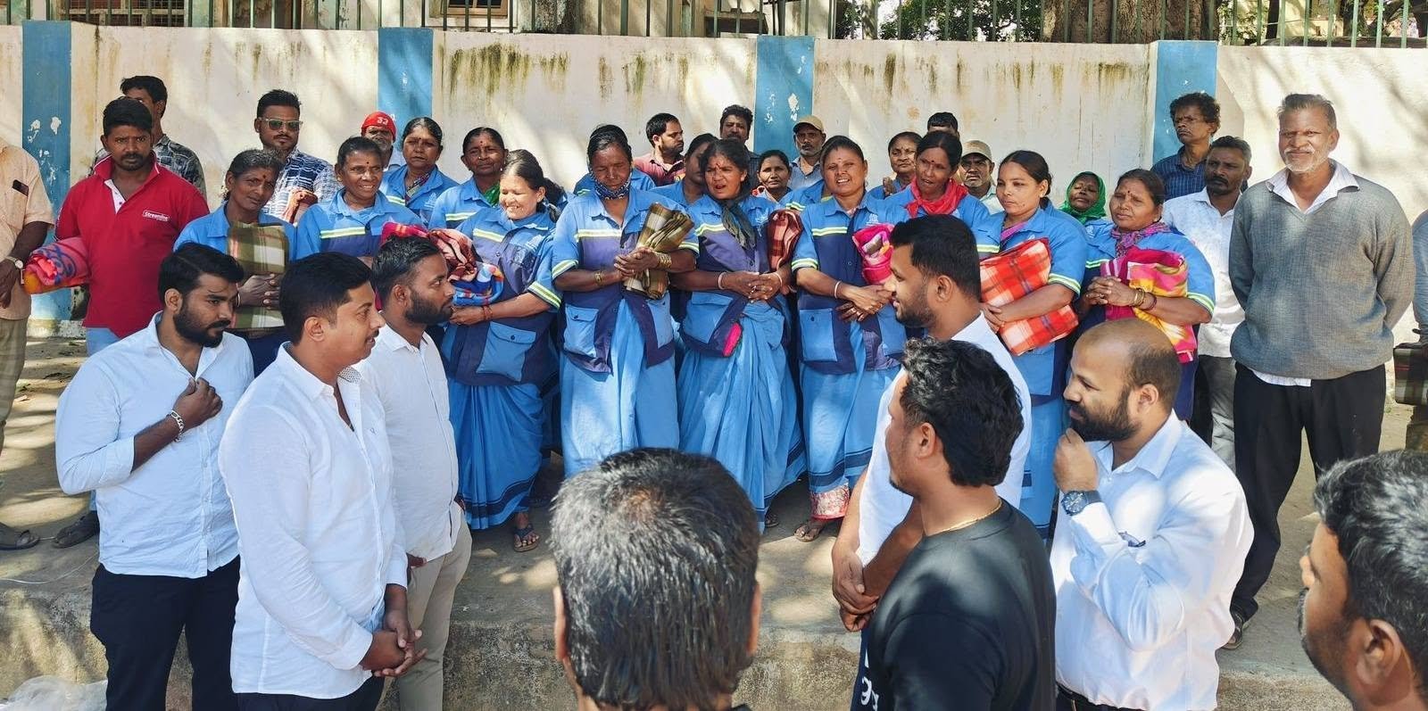 Community members receiving blankets