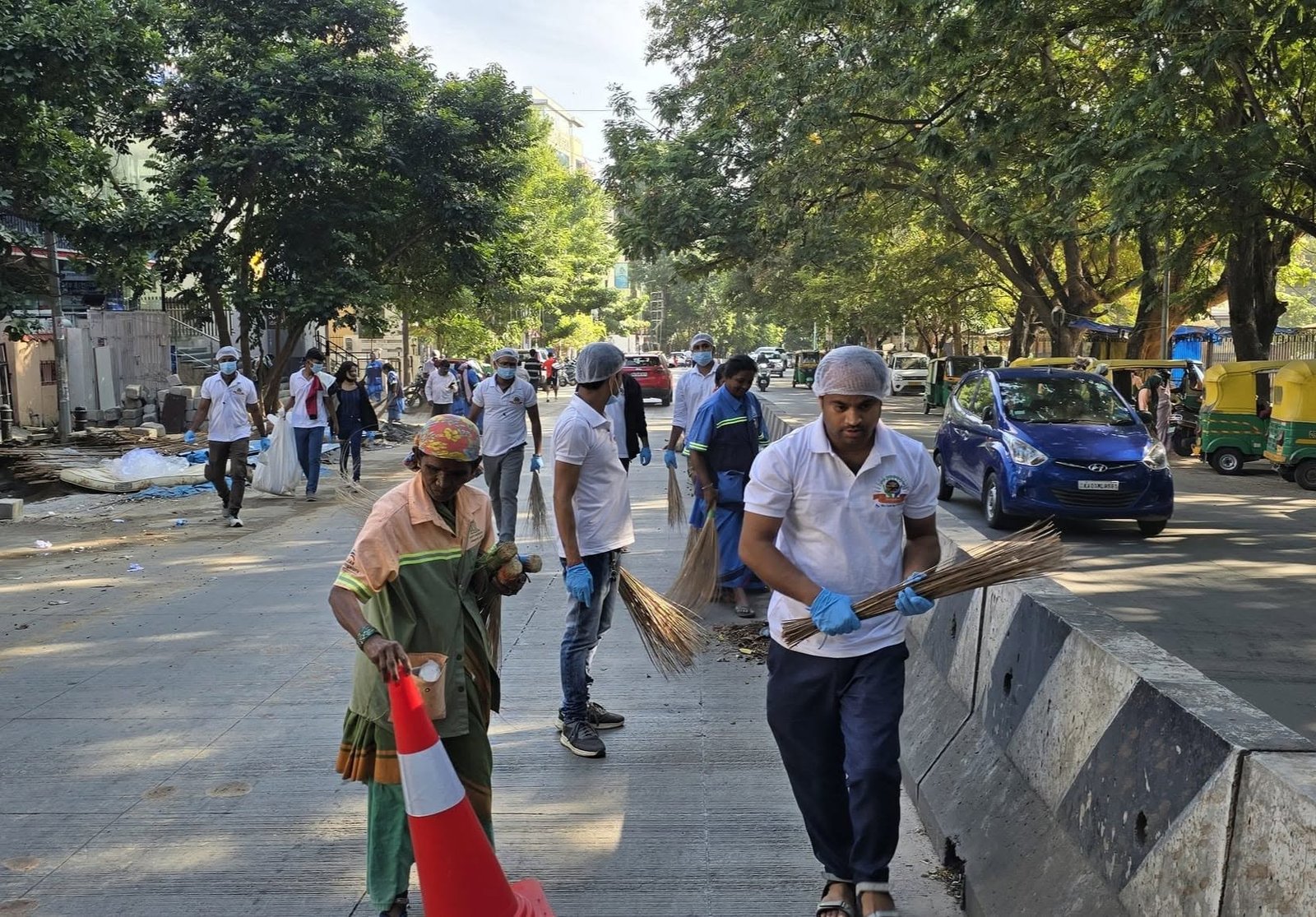 Volunteers and sanitation workers cleaning the street
