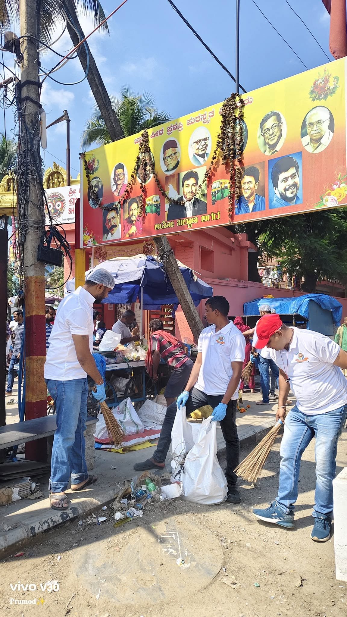 Volunteers collecting litter near the temple